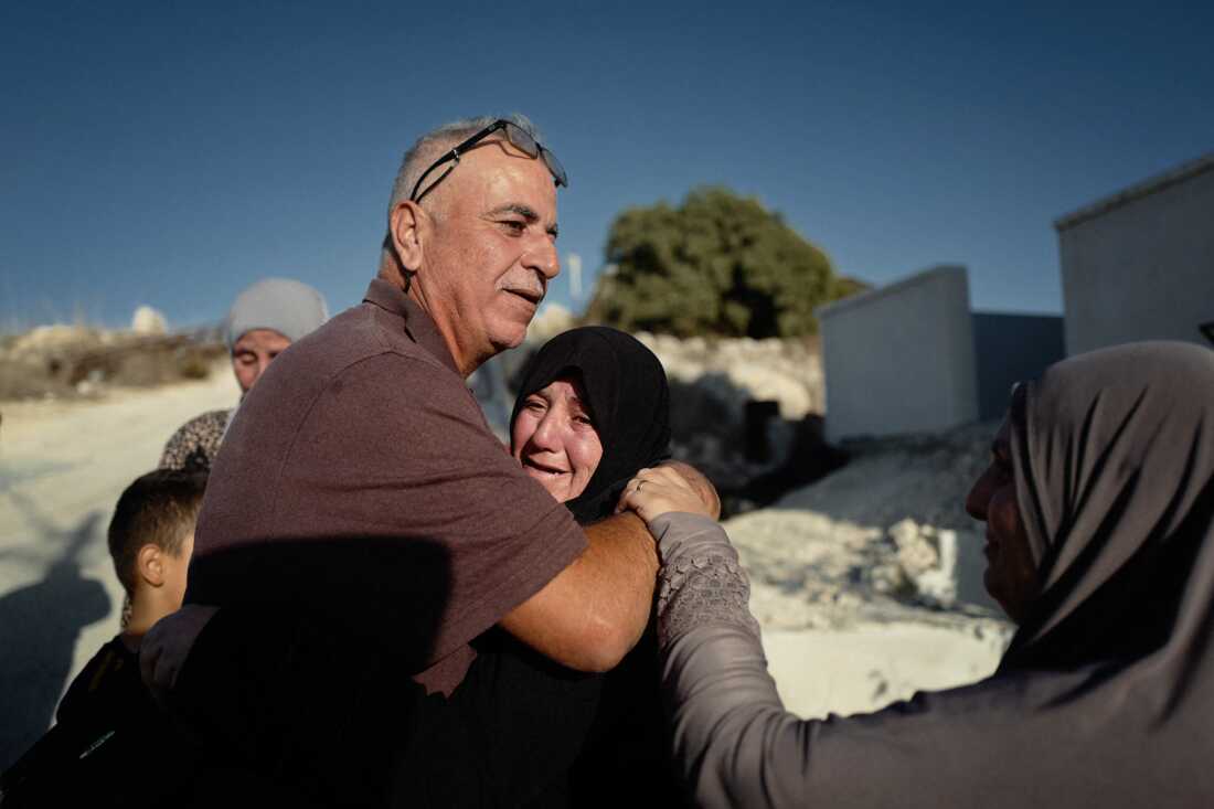 Palestinian farmer Ayoub Abu Hejleh is reunited with his family after being detained for hours by Israeli forces in the occupied West Bank in November 2023.