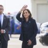 Vice President Harris waves after landing in Flint, Mich., on Oct. 4.