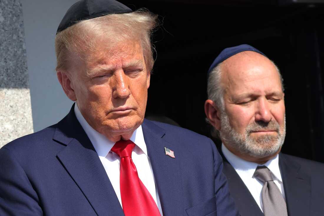 Former President Donald Trump prays at Ohel Chabad Lubavitch, the final resting place of Rabbi Menachem Mendel Schneerso, in New York on Monday with the family of Edan Alexander, who was taken hostage by Hamas in the Oct. 7 attacks.