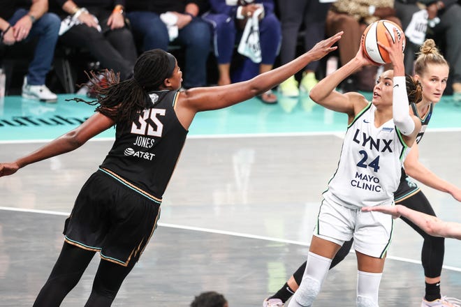 Napheesa Collier shoots a fadeaway jumper in overtime as Jonquel Jones tries to defend.