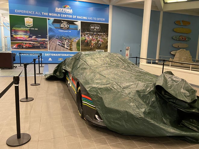 Hours after Hurricane Milton made landfall near Siesta Key, Florida, the storm's winds caused a 30-foot piece of skylight to fall from the roof of the Melbourne Orlando International Airport (across the state) at 2 a.m. Thursday, Oct. 10, 2024. Greg Donovan, executive director of Melbourne Orlando International Airport, shows the NASCAR vehicle on display that avoided a direct hit from the busted skylight nearby.