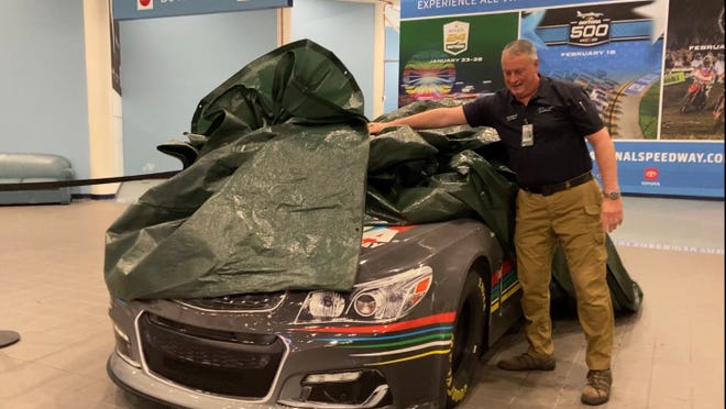 Hours after Hurricane Milton made landfall near Siesta Key, Florida, the storm's winds caused a 30-foot piece of skylight to fall from the roof of the Melbourne Orlando International Airport (across the state) at 2 a.m. Thursday, Oct. 10, 2024. Greg Donovan, executive director of Melbourne Orlando International Airport, shows the NASCAR vehicle on display that avoided a direct hit from the busted skylight nearby.