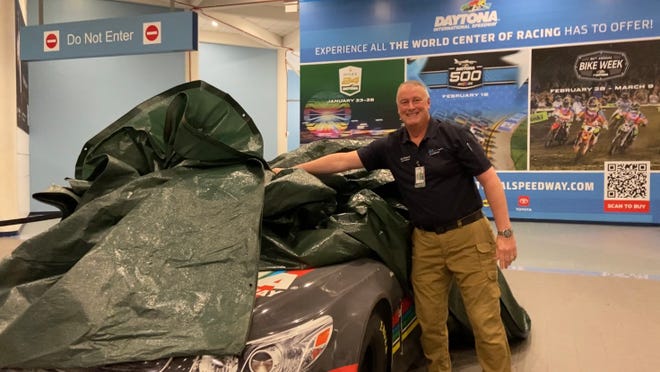 Hours after Hurricane Milton made landfall near Siesta Key, Florida, the storm's winds caused a 30-foot piece of skylight to fall from the roof of the Melbourne Orlando International Airport (across the state) at 2 a.m. Thursday, Oct. 10, 2024. Greg Donovan, executive director of Melbourne Orlando International Airport, shows the NASCAR vehicle on display that avoided a direct hit from the busted skylight nearby.