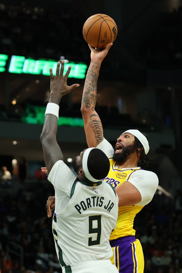 Lakers star Anthony Davis shoots over the Milwaukee Bucks’ Bobby...