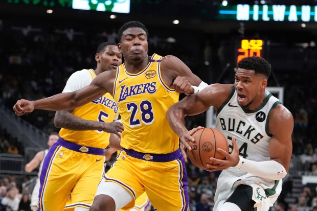 Milwaukee Bucks star Giannis Antetokounmpo drives as Lakers forward Rui...