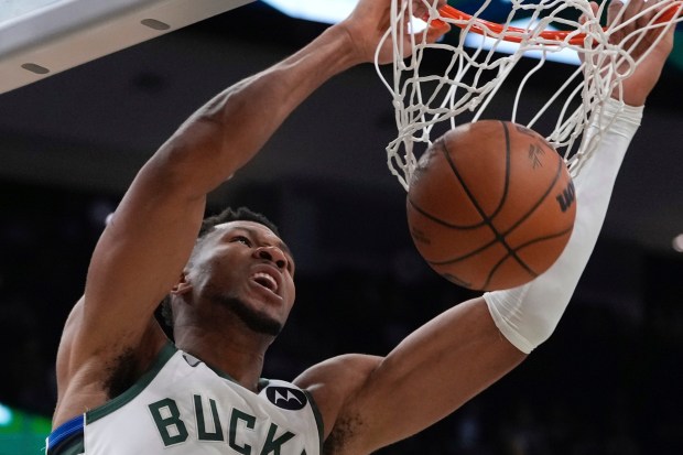 Milwaukee Bucks star Giannis Antetokounmpo dunks during the first half...