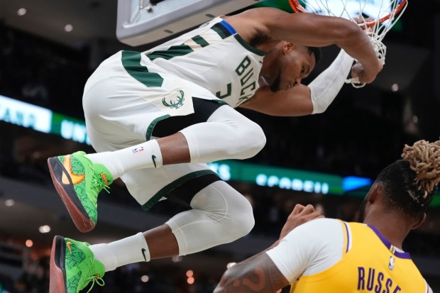 Milwaukee Bucks star Giannis Antetokounmpo dunks over Lakers guard D’Angelo...