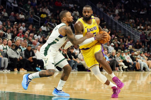 Lakers star LeBron James drives to the basket as Milwaukee...