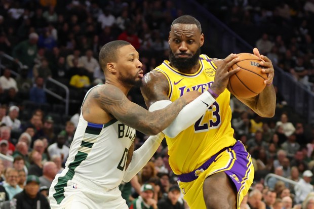 Lakers star LeBron James drives to the basket as Milwaukee...