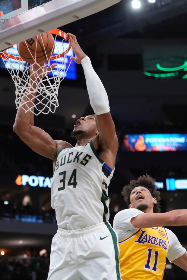 Milwaukee Bucks star Giannis Antetokounmpo dunks in front of Lakers...