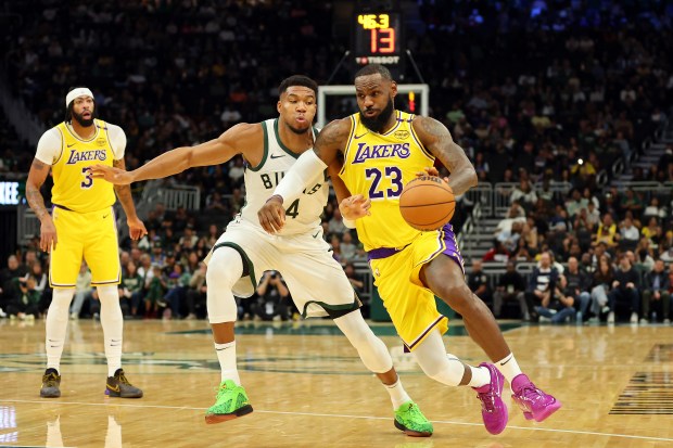 Lakers star LeBron James drives to the basket as Milwaukee...