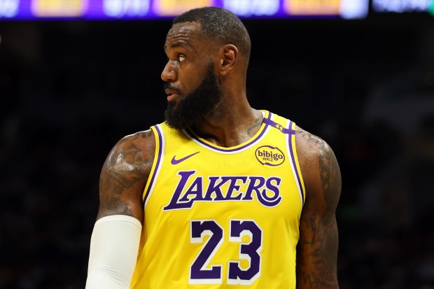 Lakers star LeBron James walks back down the court during...