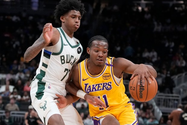 The Lakers’ Quincy Olivari tries to get past the Milwaukee...