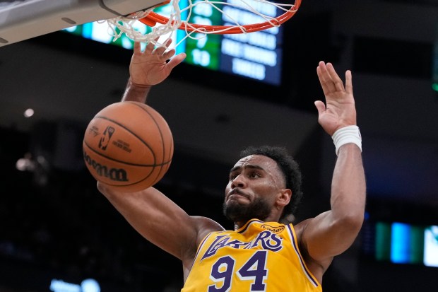 The Lakers’ Armel Traore dunks during the second half of...