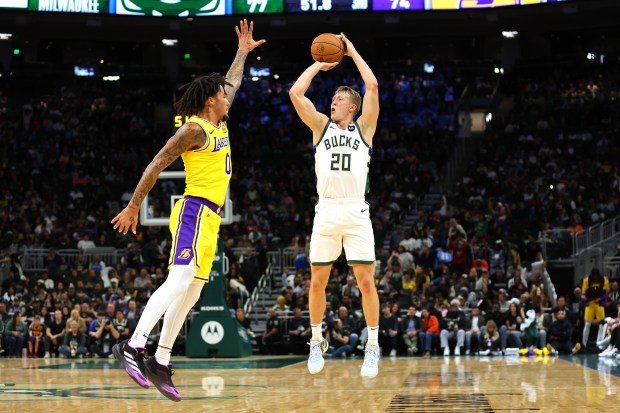 The Milwaukee Bucks’ AJ Green shoots as Lakers guard Jalen...