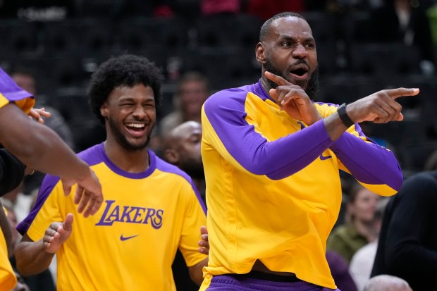 Lakers star LeBron James, right, and his son, Lakers rookie...