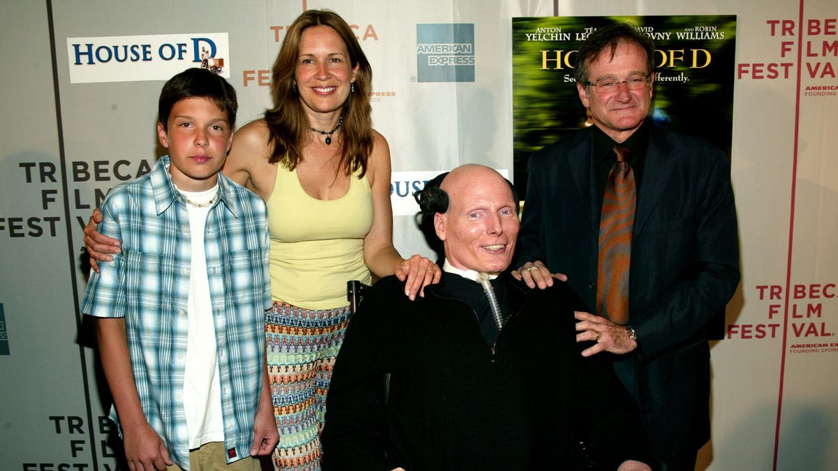 A photo of Christopher Reeve with his wife and son and Robin Williams