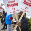 Boeing workers hold signs on the picket line at the Renton assembly plant on Friday in Renton, Wash.