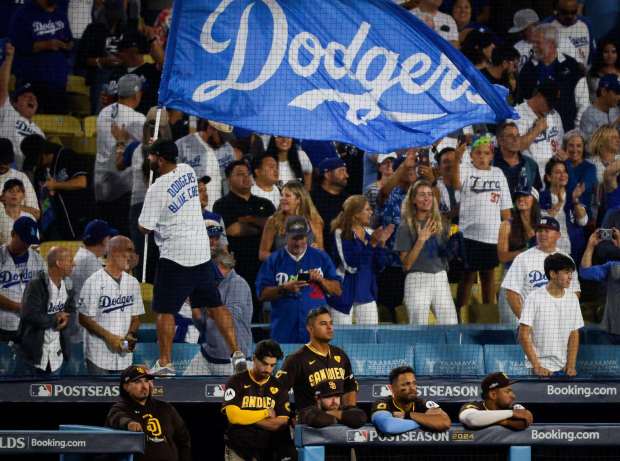 San Diego Padres' Donovan Solano, center, and teammates look on after the Padres loss against the Los Angeles Dodgers during Game 5 of the NLDS at Dodger Stadium on Friday, Oct. 11, 2024 in Los Angeles, CA. (Meg McLaughlin / The San Diego Union-Tribune)