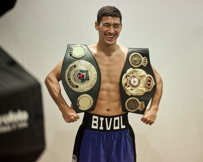 Dmitry Bivol poses with his WBA and IBO light heavyweight titles ahead of his undisputed title fight against unified champion Artur Beterbiev on Oct. 12.