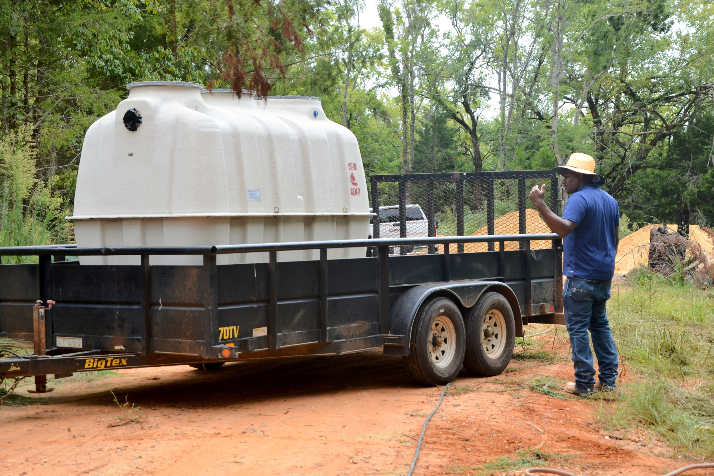 Sears Smith, a supervisor for Kess Environmental Services, directs the installation of a Fuji Clean septic treatment system at a mobile home in Lowndes County. Credit: Dennis Pillion/Inside Climate News 