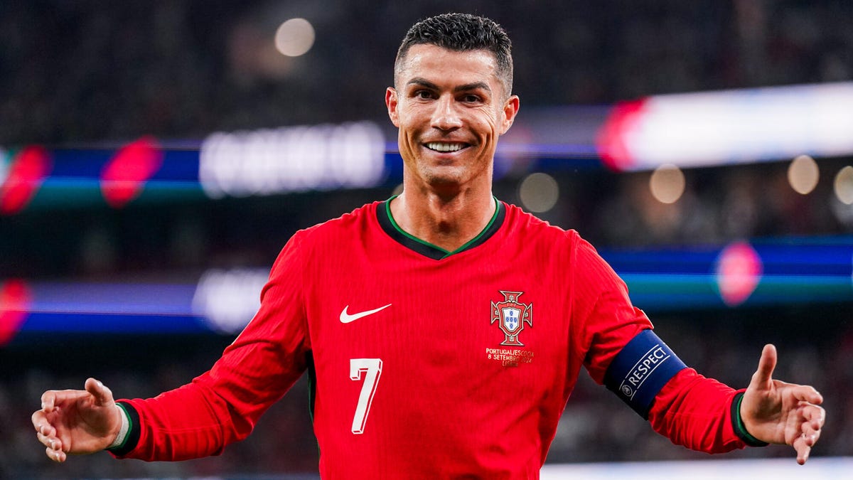 Cristiano Ronaldo of Portugal celebrating smiling, with arms outstretched.