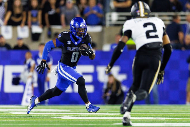 Oct 12, 2024; Lexington, Kentucky, USA; Kentucky Wildcats running back Demie Sumo-Karngbaye (0) runs the ball against Vanderbilt Commodores linebacker Randon Fontenette (2) during the second quarter at Kroger Field. Mandatory Credit: Jordan Prather-Imagn Images