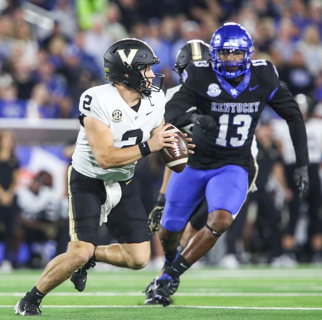 Llinebacker J.J. Weaver (13) of the Kentucky Wildcats tries to pressure quarterback Diego Pavia (2) of the Vanderbilt Commodores in the first half Saturday, Oct. 12, 2024 in Lexington, Ky.