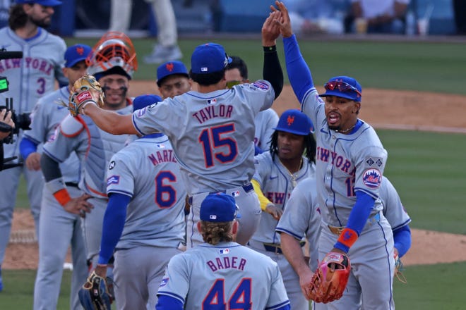 Oct 14, 2024; Los Angeles, California, USA; New York Mets shortstop Francisco Lindor (12) reacts with outfielder Tyrone Taylor (15) after game two of the NLCS for the 2024 MLB Playoffs at Dodger Stadium. Mandatory Credit: Jason Parkhurst-Imagn Images