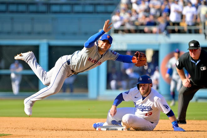 Los Angeles Dodgers third baseman Max Muncy (13) is out at second base against New York Mets second baseman Jose Iglesias (11) on a double play in the sixth inning during game two of the NLCS for the 2024 MLB Playoffs on Oct. 14, 2024, at Dodger Stadium.