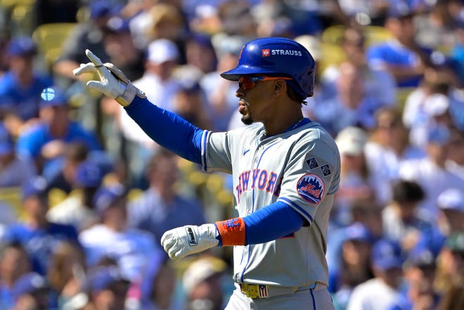 New York Mets shortstop Francisco Lindor (12) celebrates after scoring on a solo home run in the first inning against the Los Angeles Dodgers during Game 2 of the NLCS for the 2024 MLB Playoffs on Oct. 14, 2024, at Dodger Stadium.