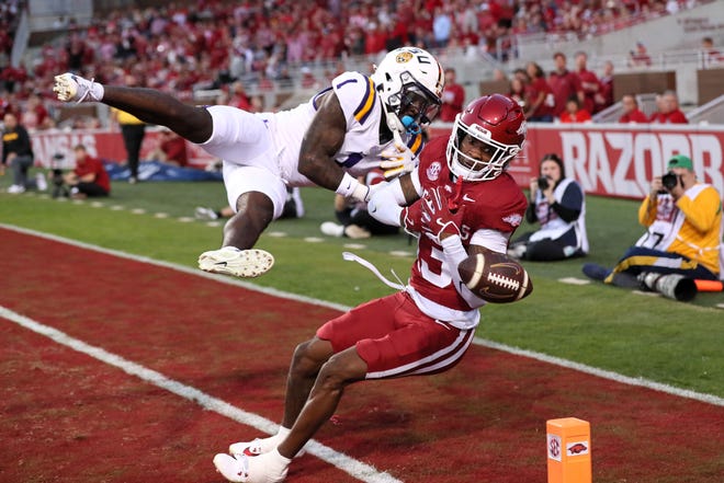 Oct 19, 2024; Fayetteville, Arkansas, USA; Arkansas Razorbacks defensive back Marquise Robinson (13) defends a pass intended for LSU Tigers wide receiver Aaron Anderson (1) during the first quarter at Donald W. Reynolds Razorback Stadium. Mandatory Credit: Nelson Chenault-Imagn Images