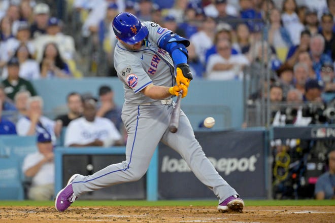 Oct 20, 2024; Los Angeles, California, USA; New York Mets first baseman Pete Alonso (20) hits a single in the third inning against the Los Angeles Dodgers during game six of the NLCS for the 2024 MLB playoffs on Oct. 20, 2024, at Dodger Stadium.