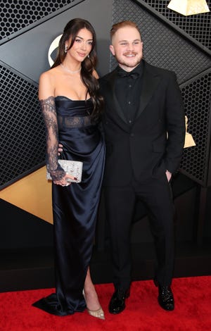 Zach Bryan, right, and Brianna "Chickenfry" LaPaglia, pictured earlier this year at the Grammy Awards in February 2024. Bryan announced the pair's breakup in an Oct. 22, 2024, statement on his Instagram story.