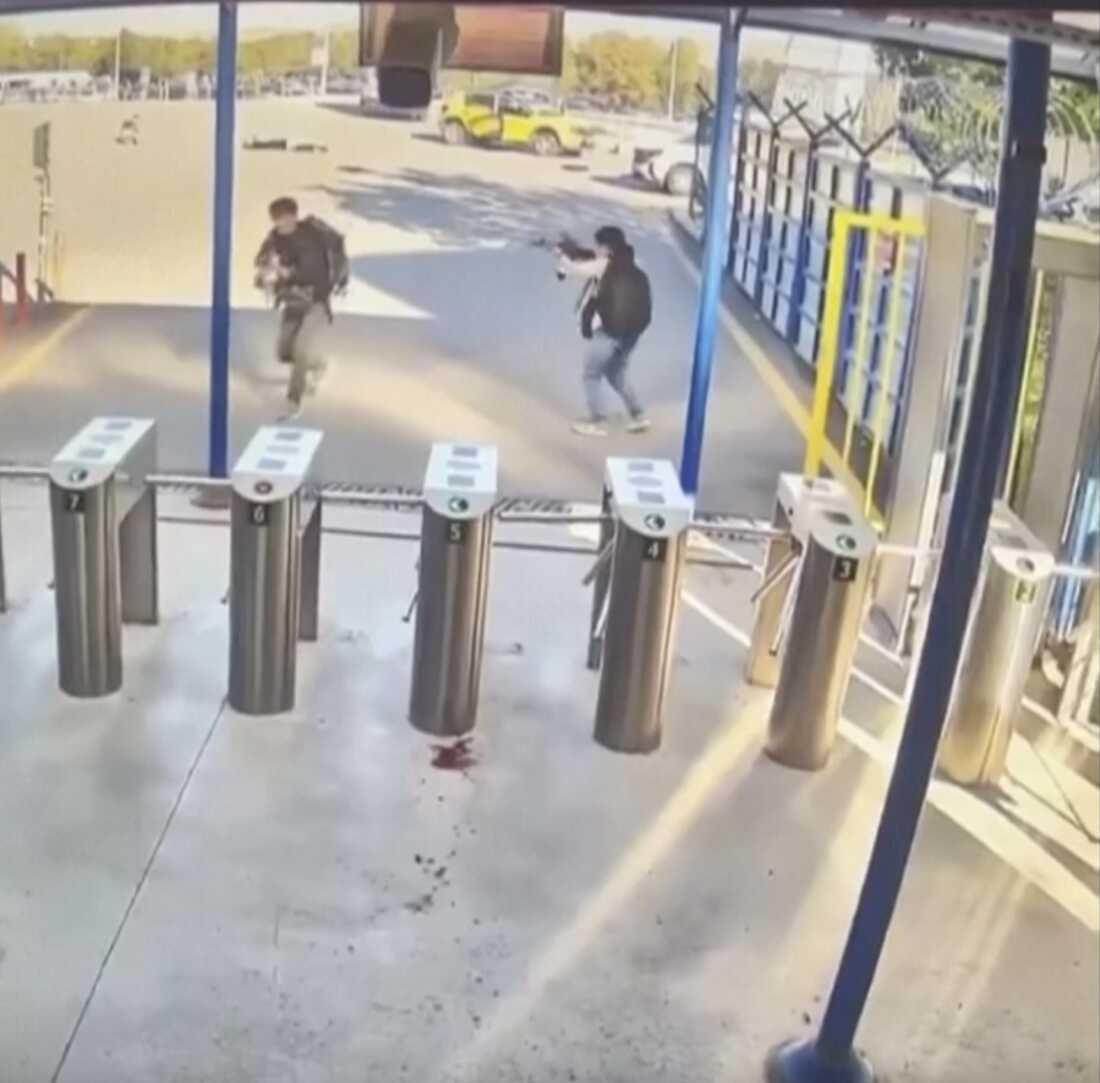 This image taken from security camera video shows two people with guns and backpacks during an attack on the premises of the Turkish state-run aerospace and defense company TUSAS, on the outskirts of Ankara, Turkey, Wednesday.