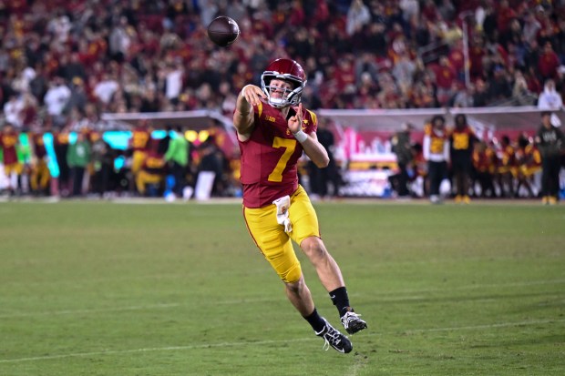 USC quarterback Miller Moss throws a pass toward the end...