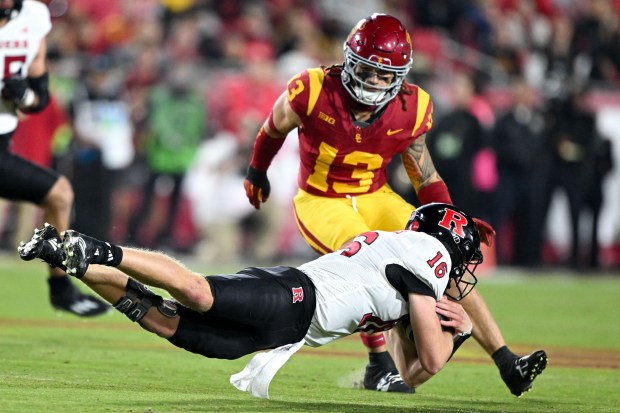 Rutgers quarterback Athan Kaliakmanis dives for extra yardage as USC...