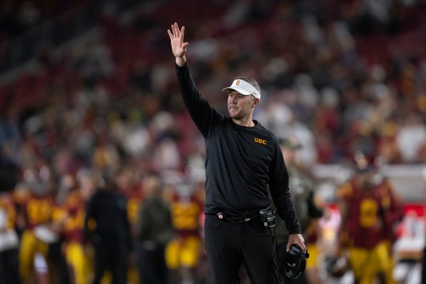 USC head coach Lincoln Riley gestures from the sideline during...