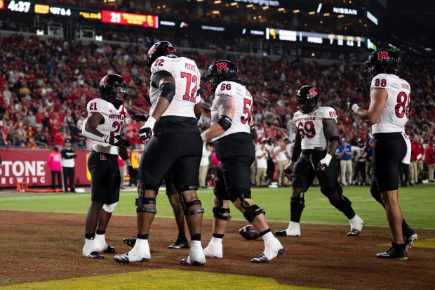 Rutgers players celebrate a touchdown by running back Antwan Raymond...