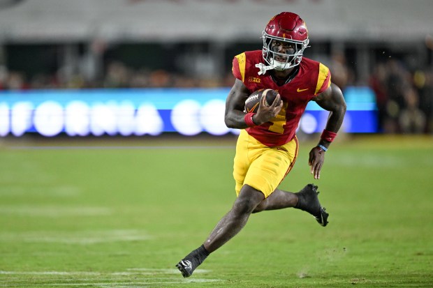 USC running back Woody Marks carries the ball on his...