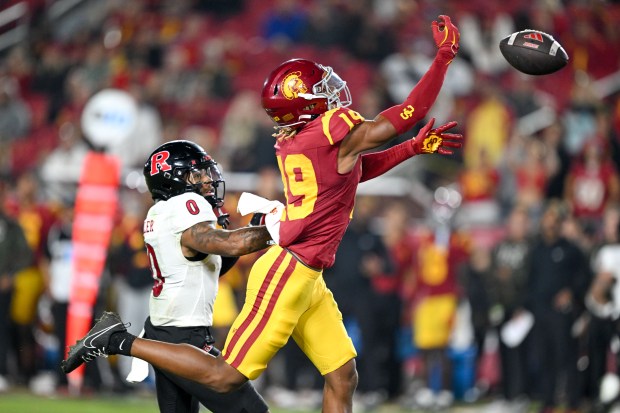 USC defensive back John Humphrey, right, breaks up a pass...