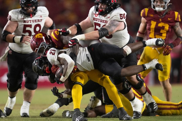 USC defensive end Sam Greene (44) tackles Rutgers running back...