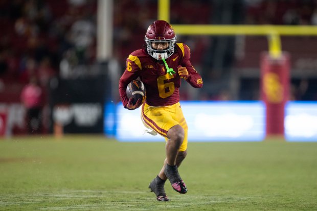 USC wide receiver Makai Lemon runs with the ball for...