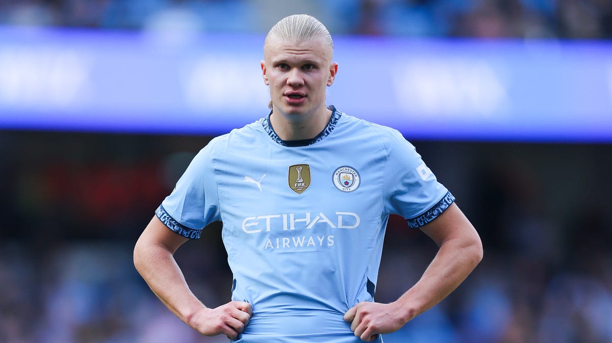 Erling Haaland of Manchester City standing with his hands on his hips.