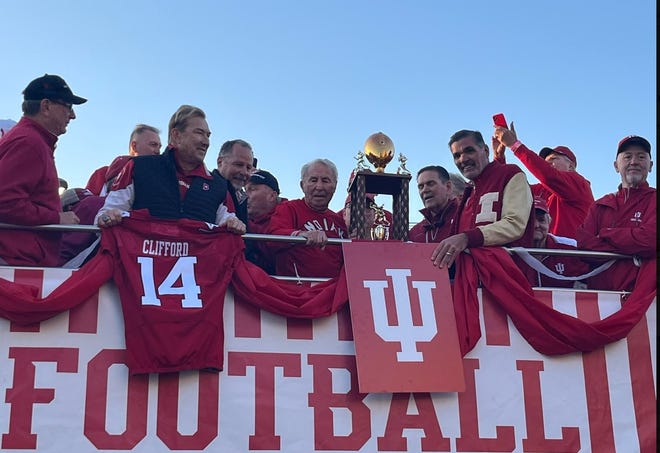 Lee Corso (center) and members of the 1979 Holiday Bowl team make a grand entrance on ESPN's College GameDay on a double-decker bus.