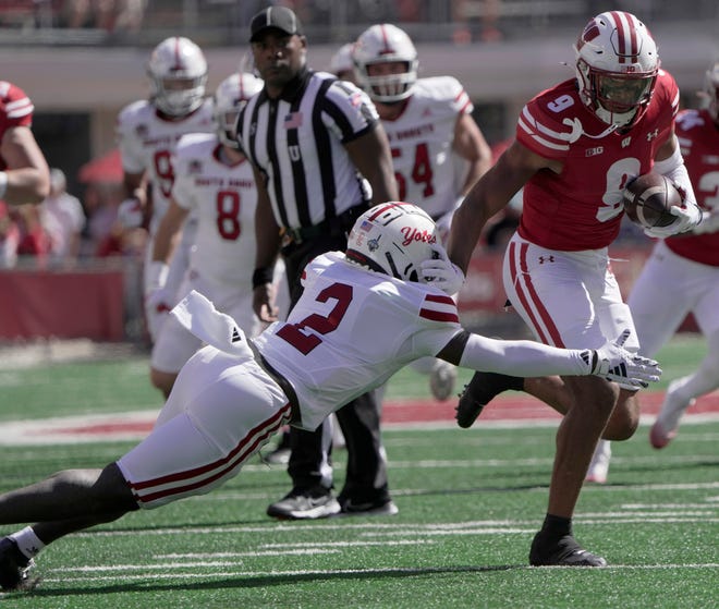 Wisconsin wide receiver Bryson Green (9) evades a tackle by South Dakota defensive back Dennis Shorter (2) while picking up a first down on a reception during the first quarter of their game Saturday, September 7 , 2024 at Camp Randall Stadium in Madison, Wisconsin.