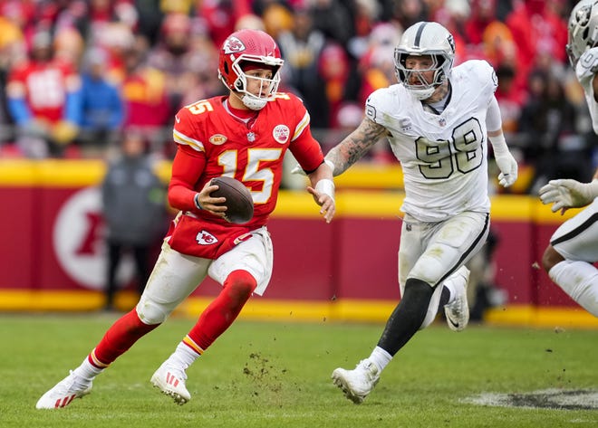 Kansas City Chiefs quarterback Patrick Mahomes (15) scrambles against Las Vegas Raiders defensive end Maxx Crosby (98) during the second half at GEHA Field at Arrowhead Stadium on Kansas City, Missouri on Dec. 25, 2023.