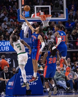 Oct 26, 2024; Detroit, Michigan, USA; Boston Celtics guard Jaylen Brown (7) shoots the ball over Detroit Pistons guard Cade Cunningham (2) for two points during the second half at Little Caesars Arena. Mandatory Credit: David Reginek-Imagn Images