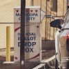 A voter drops a ballot into the drop box at the Maricopa County Tabulation and Election Center in Phoenix on Wednesday.