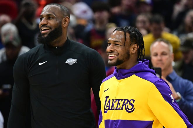 Los Angeles Lakers guard Bronny James, right, and forward LeBron James warm up before a game between the Cleveland Cavaliers and the Lakers on Wednesday in Cleveland.